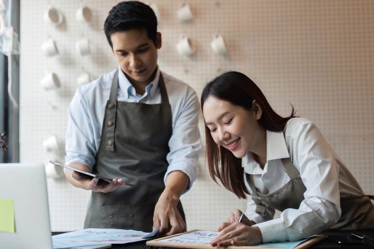Small business owners reviewing accounts, accounting services for small business Singapore